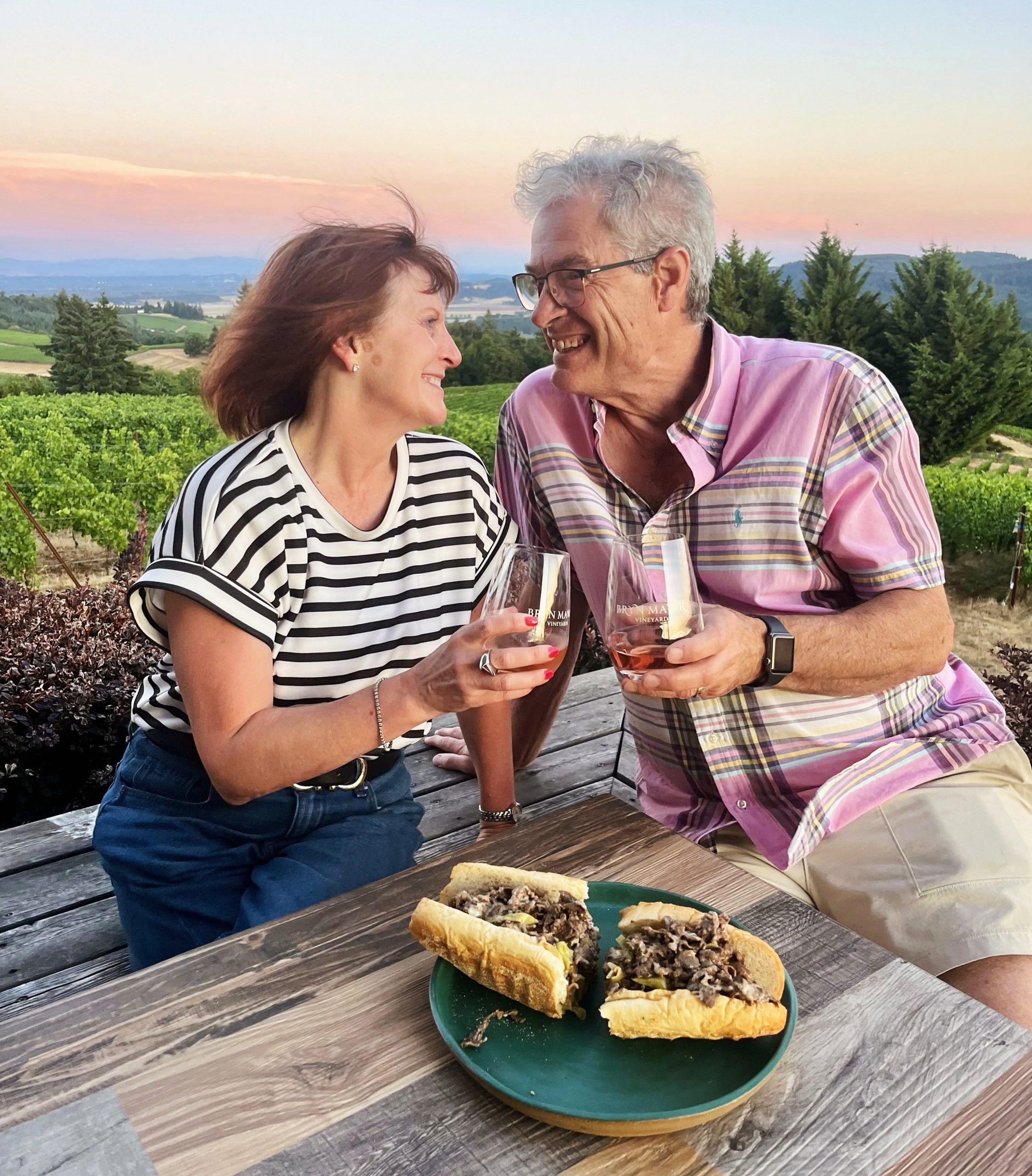 Two people toasting at an outdoor tabe