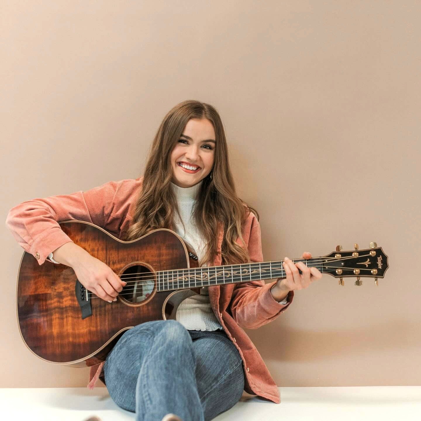 Woman holding an acoustic guitar